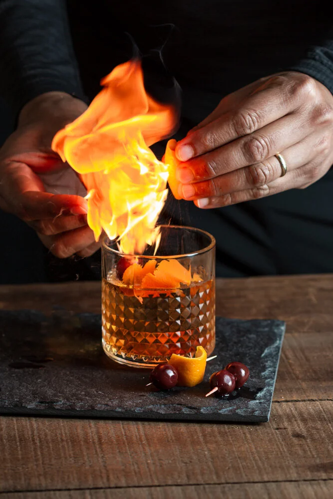 Old Fashioned with a Flaming Orange Peel Garnish